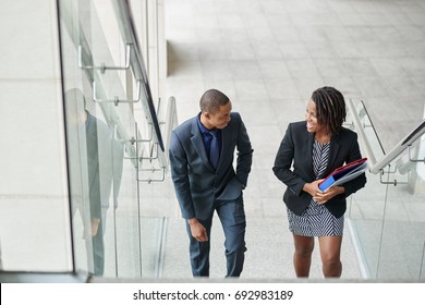 African-American Business Couple Walking Up The Stairs And Talking