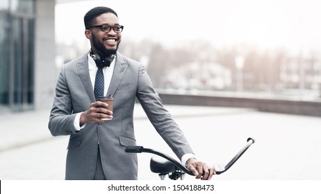 African-american Businessman Going To Work By Bike, Drinking Takeaway Coffee Near Office, Free Space