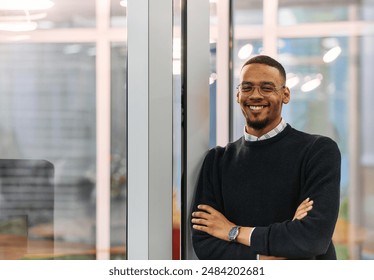 African-American Businessman Posing with Crossed Arms in Modern Office - Powered by Shutterstock