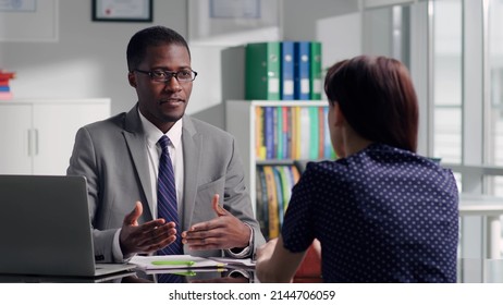African-American executive have job interview with female applicant. Back view of young woman listen to salesman or bank manager - Shutterstock ID 2144706059