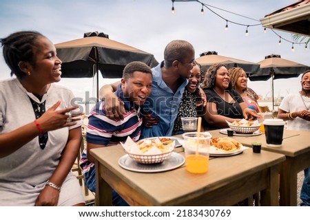 African-American family enjoying a meal at a beach restaurant.