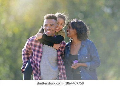 African-american family enjoying sunny autumn day  - Powered by Shutterstock