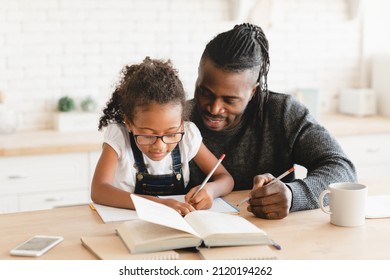 African-american father dad tutor childminder helping assisting with homework school project to a preteen daughter student. Homeschool concept. E-learning - Powered by Shutterstock