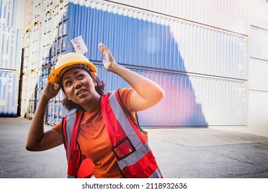 African-American Female Worker With A Helmet On Her Head Was Struck By A Steel Plate From A Height In The Container Yard. She Almost Suffered Injury But Was Fortunately Safe.