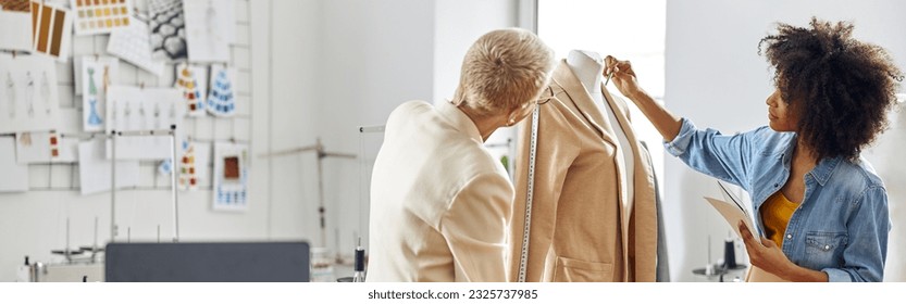 African-American lady with mature colleague fashion designers at - Powered by Shutterstock