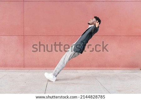 african-american man falling backwards onto concrete floor