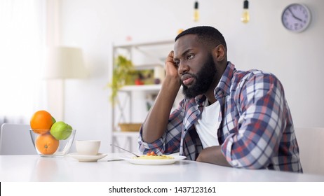 African-American man having no appetite, eating disorder, depression problem