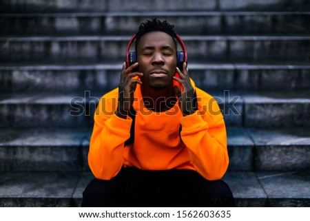 Similar – Young black man listening to music