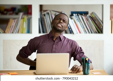 African-american Man Touching Back Sitting At Desk Feeling Sudden Backache, Black Businessman Suffering From Low-back Lumbar Pain After Sedentary Work At Laptop Computer, Incorrect Posture Problems