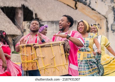 African-American Men Play Drums And Women Dance To Their Caribbean Music In The Park.