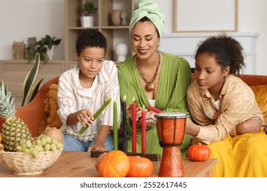 African-American mother with her children lighting up candles at home. Kwanzaa celebration - Powered by Shutterstock