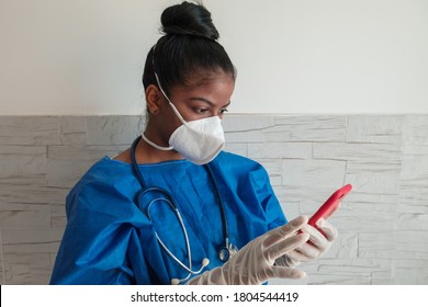 African-American nurse checking her cell phone. Black nurse