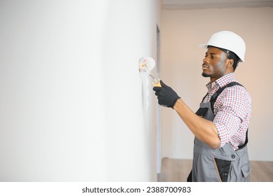 African-American painter doing repair in room. - Powered by Shutterstock