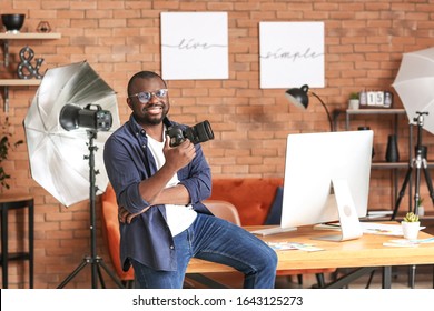 African-American Photographer In Modern Studio