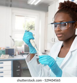 African-american Scientist Or Graduate Student In Lab Coat And Protective Wear Works In Modern Laboratory