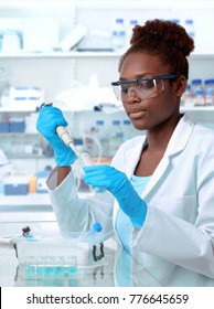 African-american Scientist Or Graduate Student In Lab Coat And Protective Wear Works In Modern Laboratory