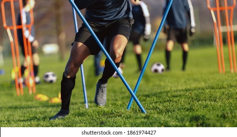 African-American Soccer Player On Training Drill. Legs Of Footballer Running On Grass Practice Field. Obstacle Course In Soccer Football. Player Running In Sports Cleats