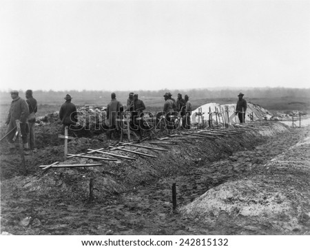 African-American soldiers of the 321st Labor Battalion in the segregated U.S. Army during World War I. They are filling trenches in which American dead are buried. December 1918.