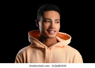 African-American Teenage Boy In Hoodie Smiling On Black Background