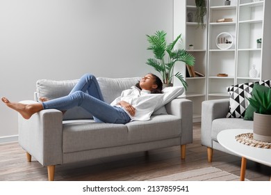 African-American teenage girl relaxing on sofa at home - Powered by Shutterstock