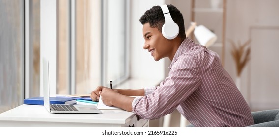 African-American teenager studying online at home - Powered by Shutterstock