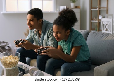 African-American teenagers playing video game at home - Powered by Shutterstock