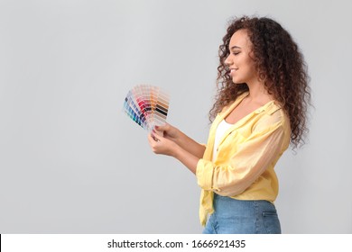 African-American woman with color palettes on grey background - Powered by Shutterstock