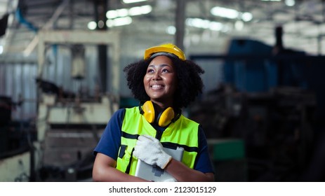African-American woman machine operator technician in the manufacturing industry happy smile in the factory