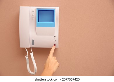 African-American woman pressing button on intercom panel indoors, closeup. Space for text