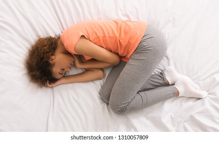 African-american Woman Sleeping, Curling Up In Bed, Top View