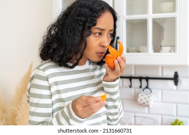African-american woman suffering from long-term effects after having coronavirus. Concept of loosing sense of smell due to covid19. Female has anosmia disease. Lack of fruit flavor and aroma - Shutterstock ID 2131660731