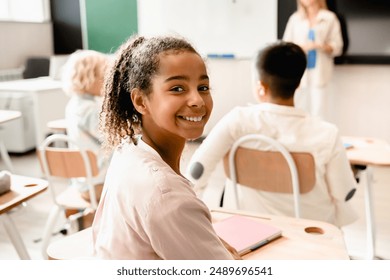 African-american young smart schoolgirl pupil student attending school lesson class listening to the teacher. Back to school. New academic year semester. - Powered by Shutterstock