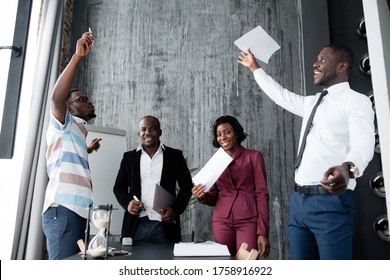 African-Americans in the company scatter joyfully documents for concluding a major contract in the office - Powered by Shutterstock