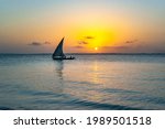 Afrikan fishing sailboat Ngalawa  on beaitiful sunset background near Mnemba island, Tanzania