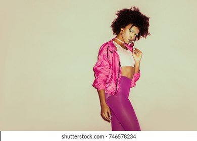 Afro 80s Girl In Pink Clothes Posing With Lollipop For Fashion Shoot