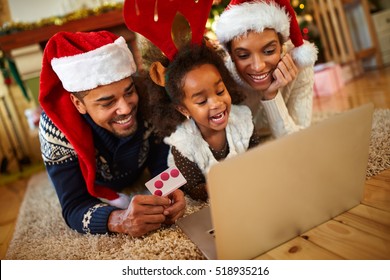 afro African family realize Christmas shopping online from warm living room at home 