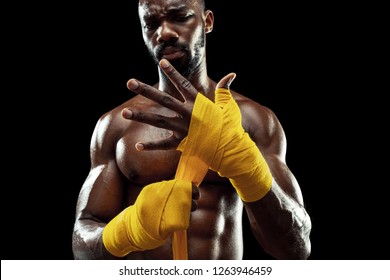 Afro American boxer is wrapping hands with yellow bandage - Powered by Shutterstock