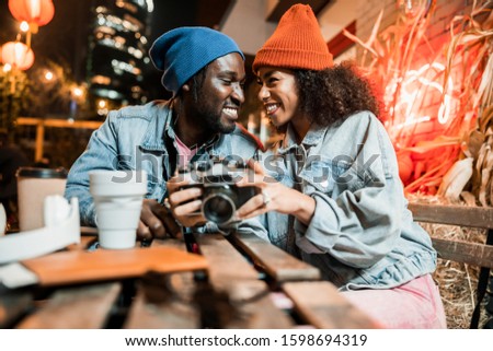 Afro American couple spending time while resting in street cafe stock photo