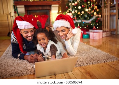 Afro American Family Use Laptop For Christmas Online Shopping