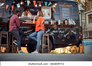 Afro american food truck employee taking orders from customers - Powered by Shutterstock