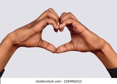 Afro American hand make heart shape on studio.