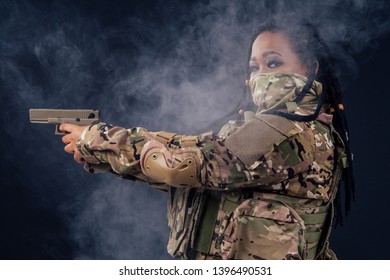 Afro American Indian Army Latin Soldier In Camouflage Clothes Hair Dreadlocks Evening Makeup In Mask On A Black Background In The Studio