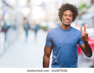 Afro american man over isolated background showing and pointing up with fingers number two while smiling confident and happy.