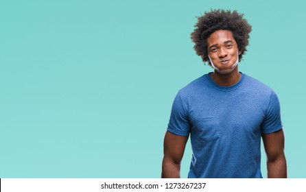 Afro american man over isolated background puffing cheeks with funny face. Mouth inflated with air, crazy expression.