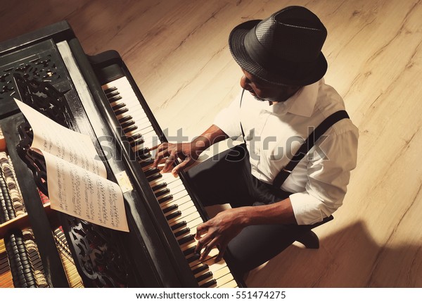 Afro American man playing\
piano