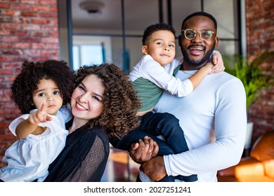 Afro American Mixed-raced Family Looking At Camera In Cozy Summer Day Light In Living Room