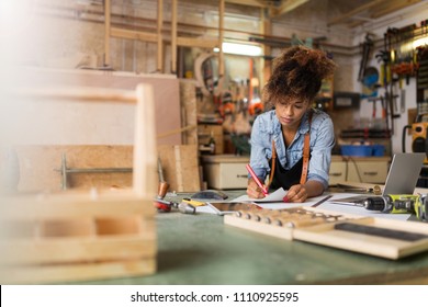 Afro american woman craftswoman working in her workshop