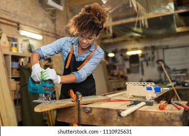 Afro american woman craftswoman working in her workshop
