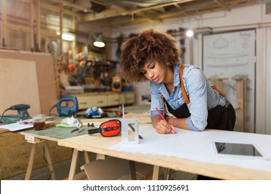 Afro american woman craftswoman working in her workshop - Powered by Shutterstock