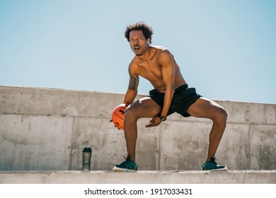 Afro Athlete Man Playing Basketball Outdoors.